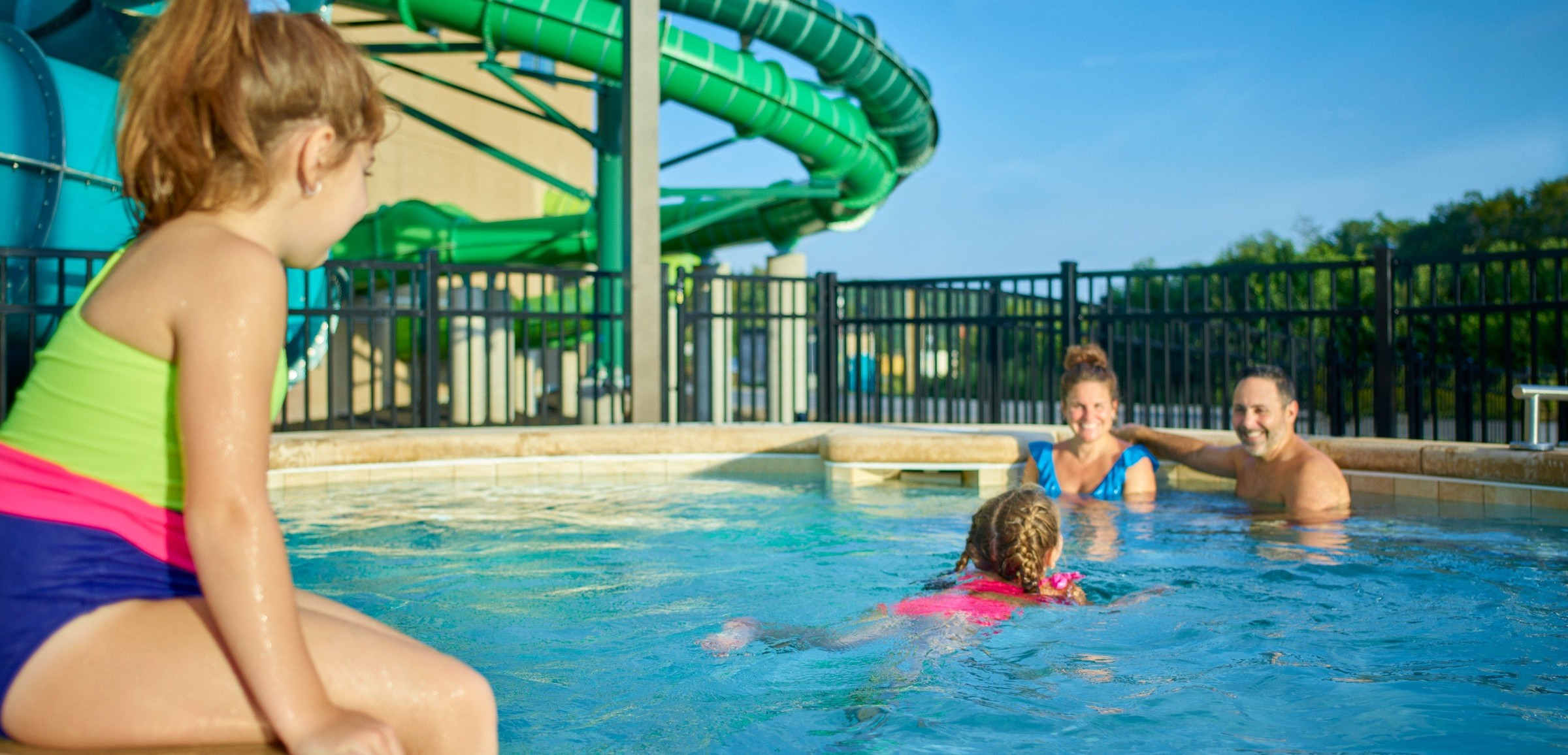 family relaxes in an outdoor hot tub