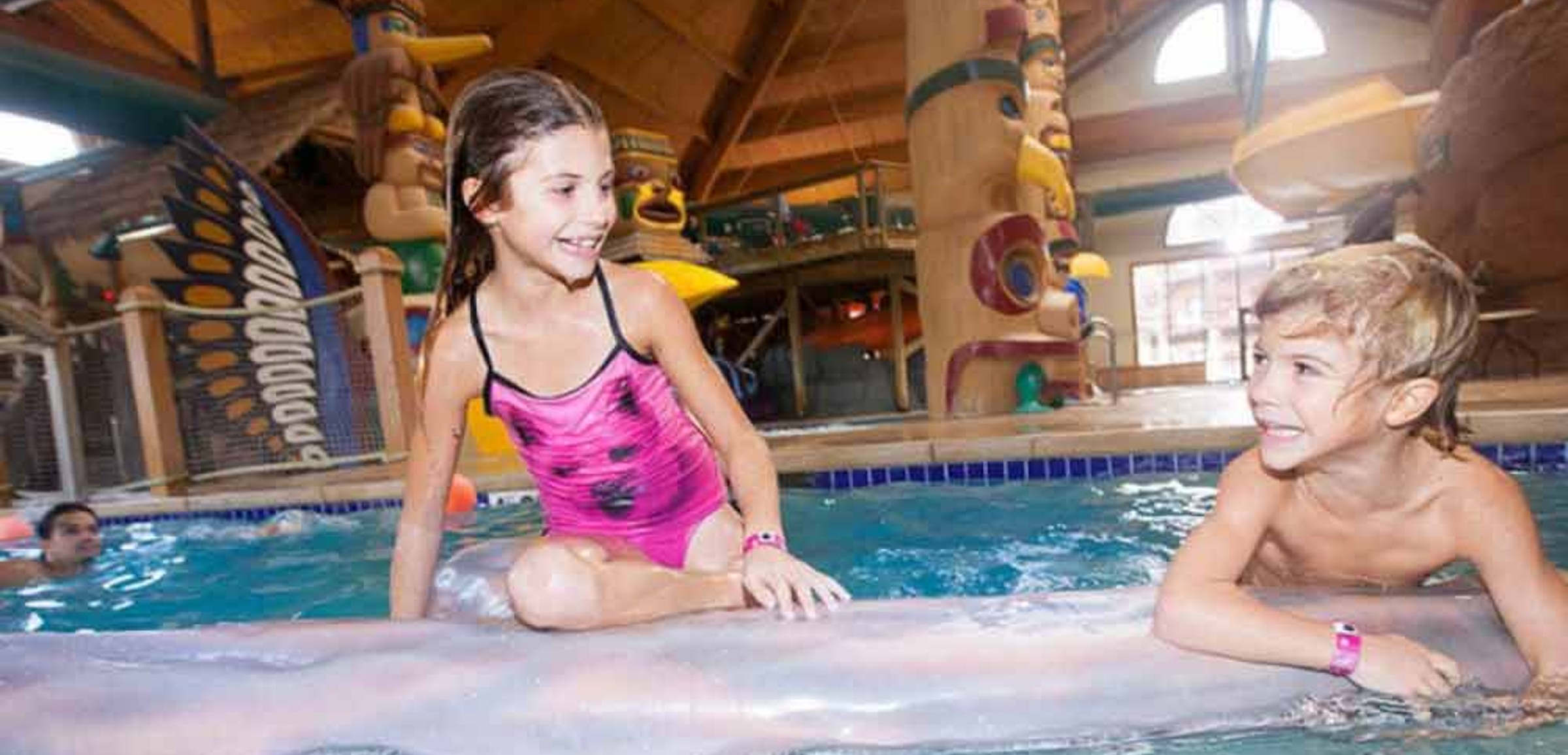 Child balances on log at Great Wolf Lodge indoor water park and resort.