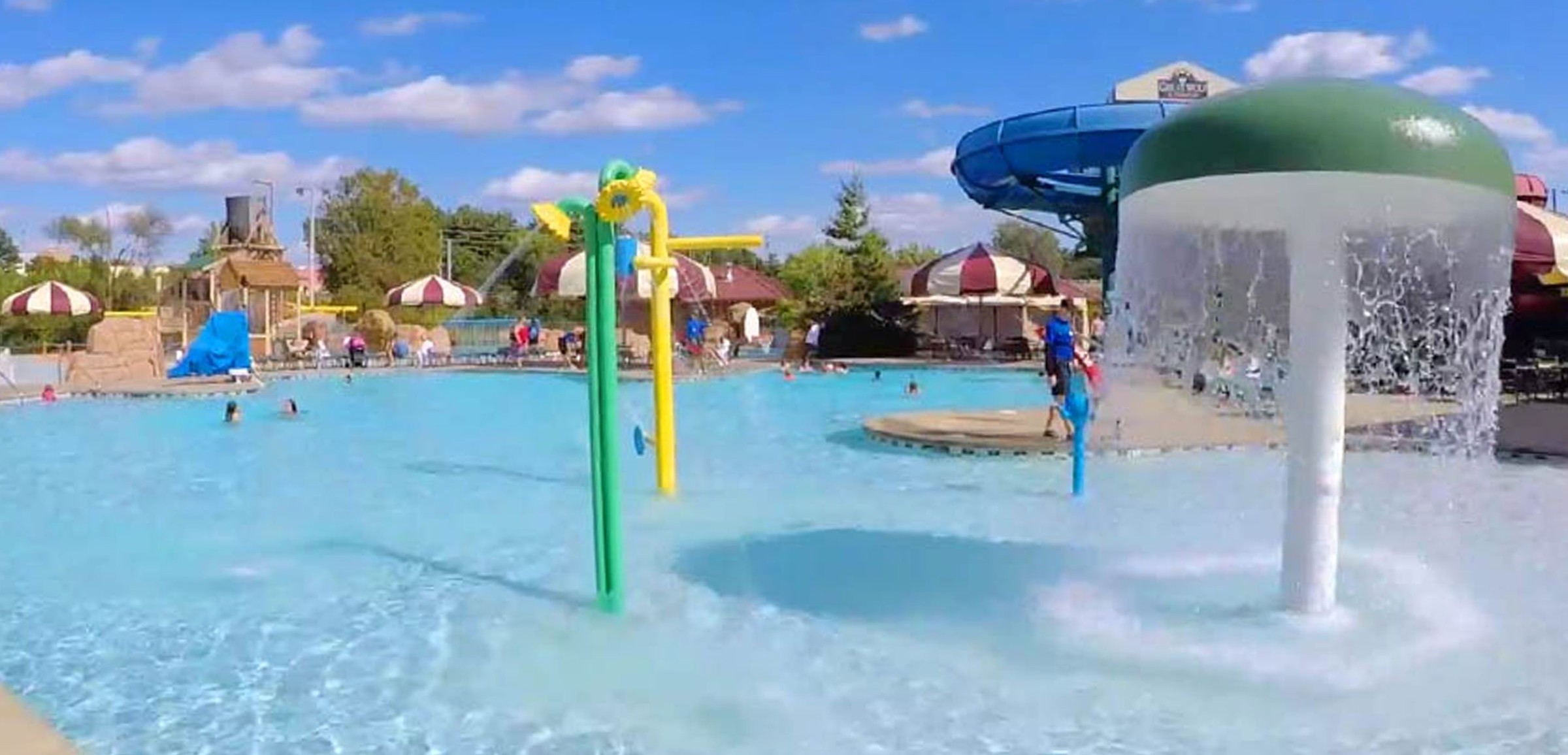Kids play behind the outdoor water features 