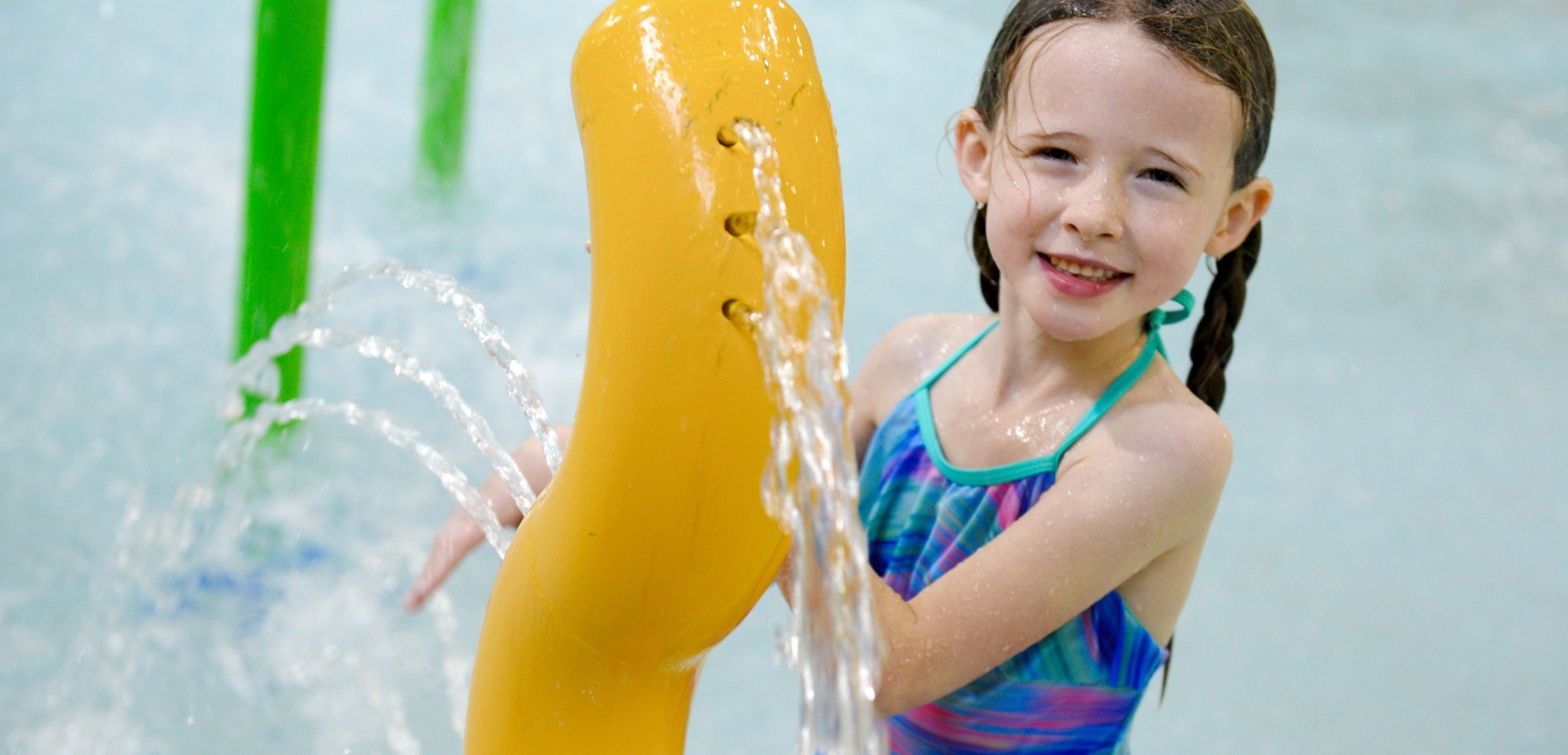 Kids play behind the outdoor water features