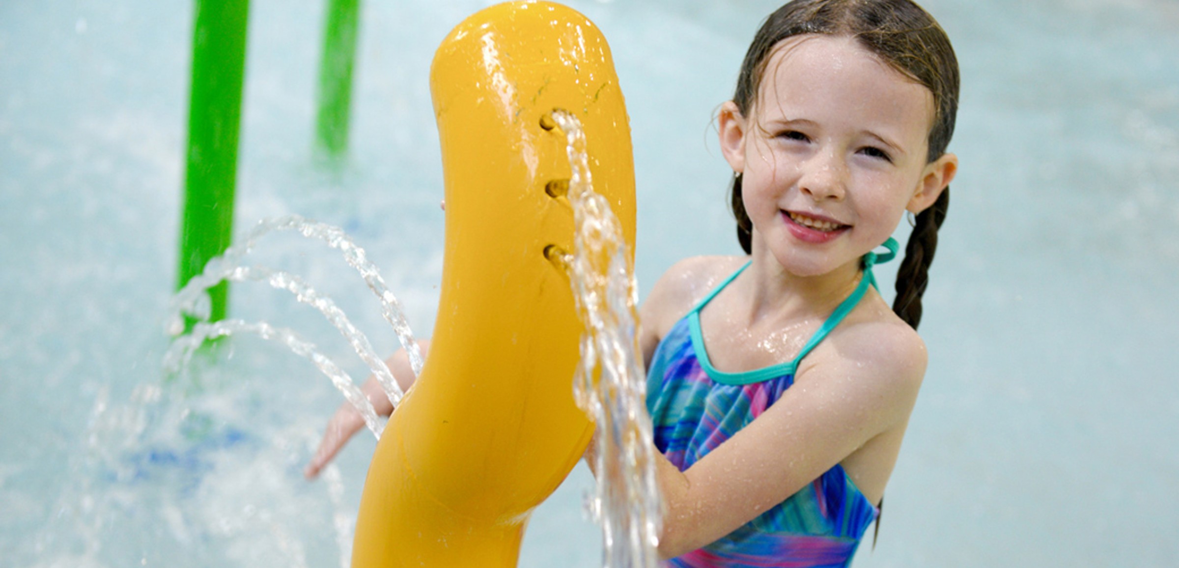 Kids play behind the outdoor water features 