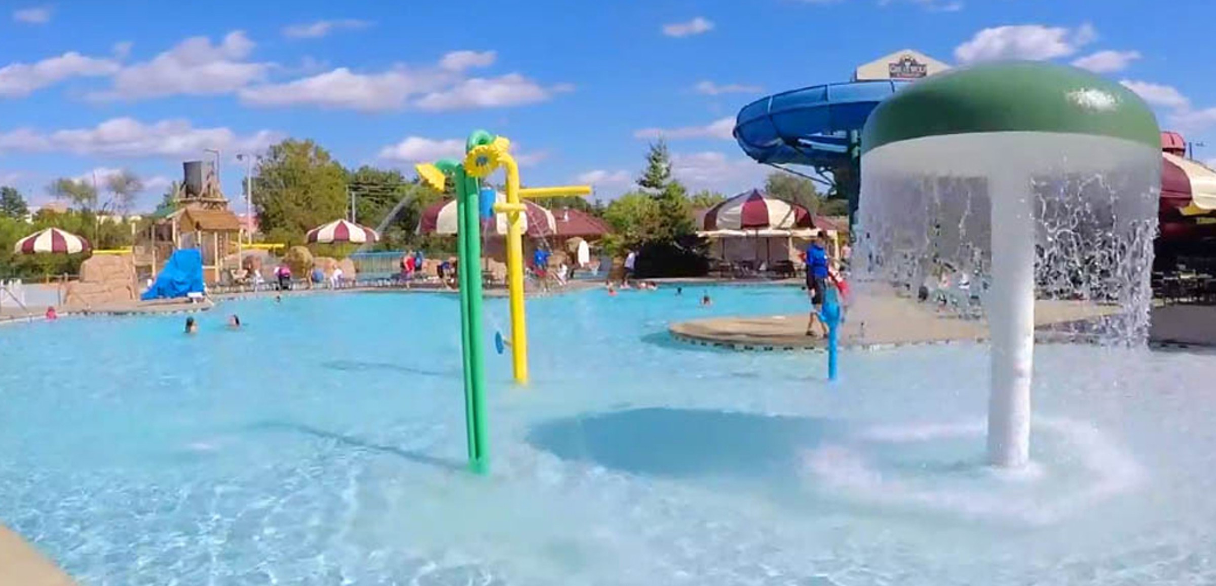 Kids play behind the outdoor water features 