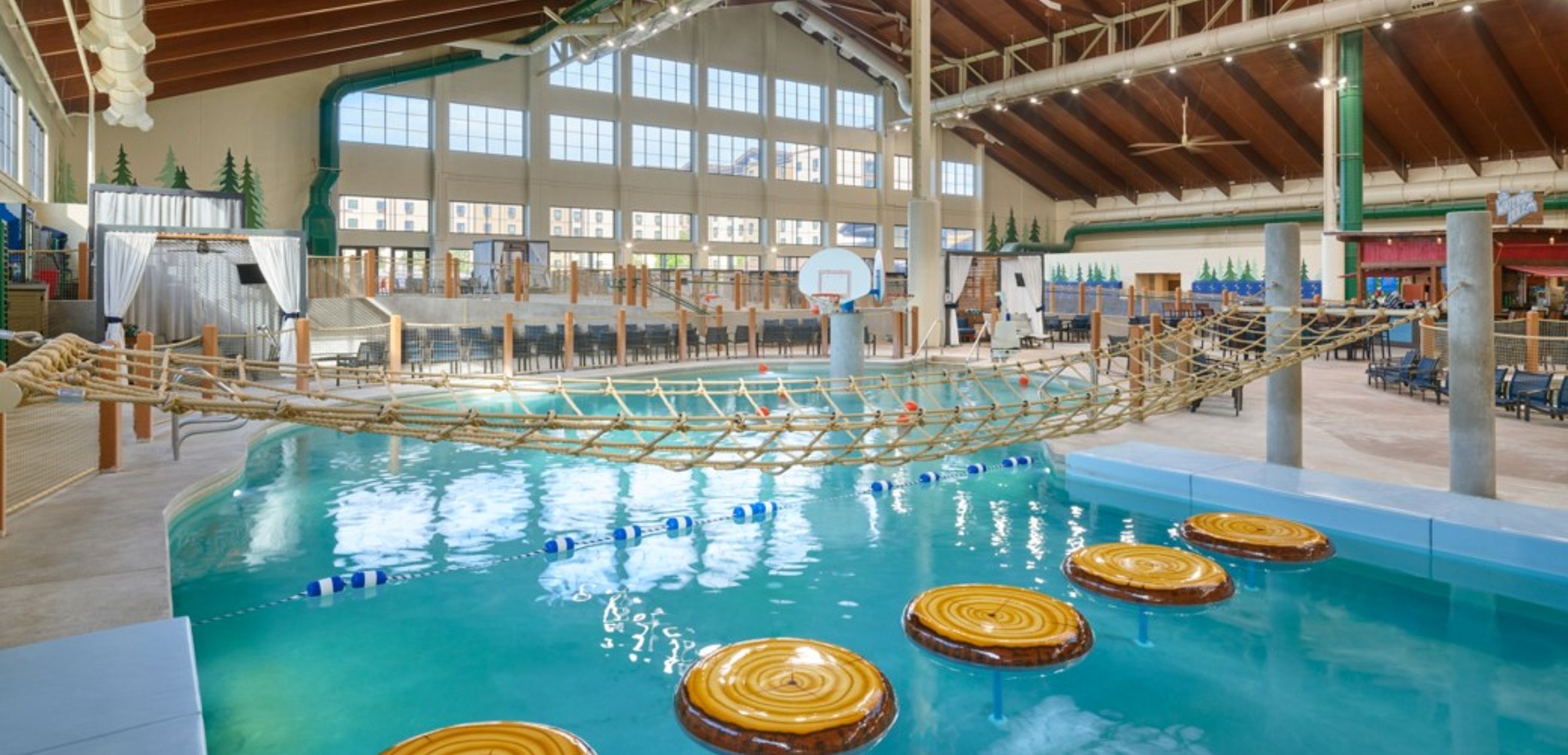 family playing basketball in indoor pool 