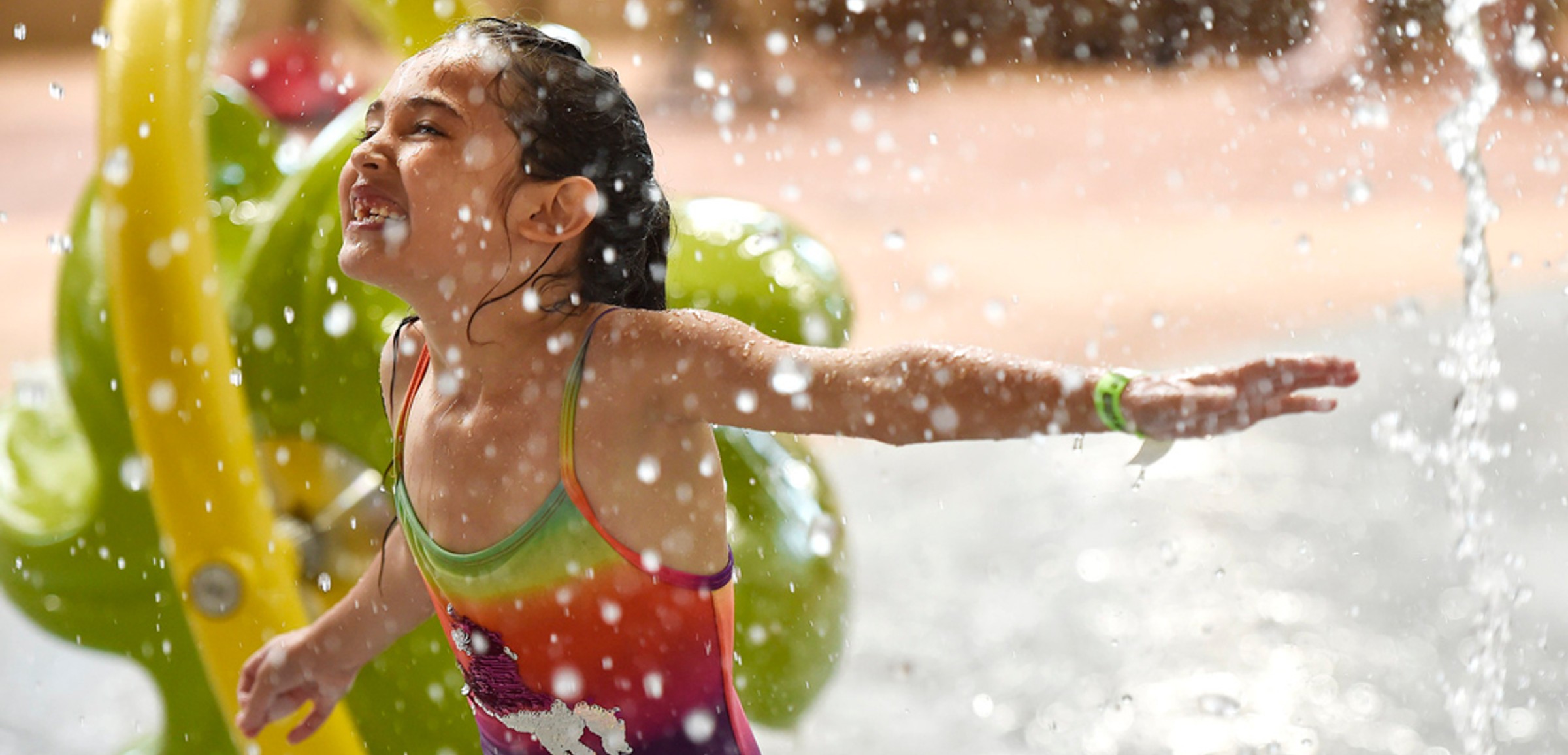 Little girl enjoying cub paw pool