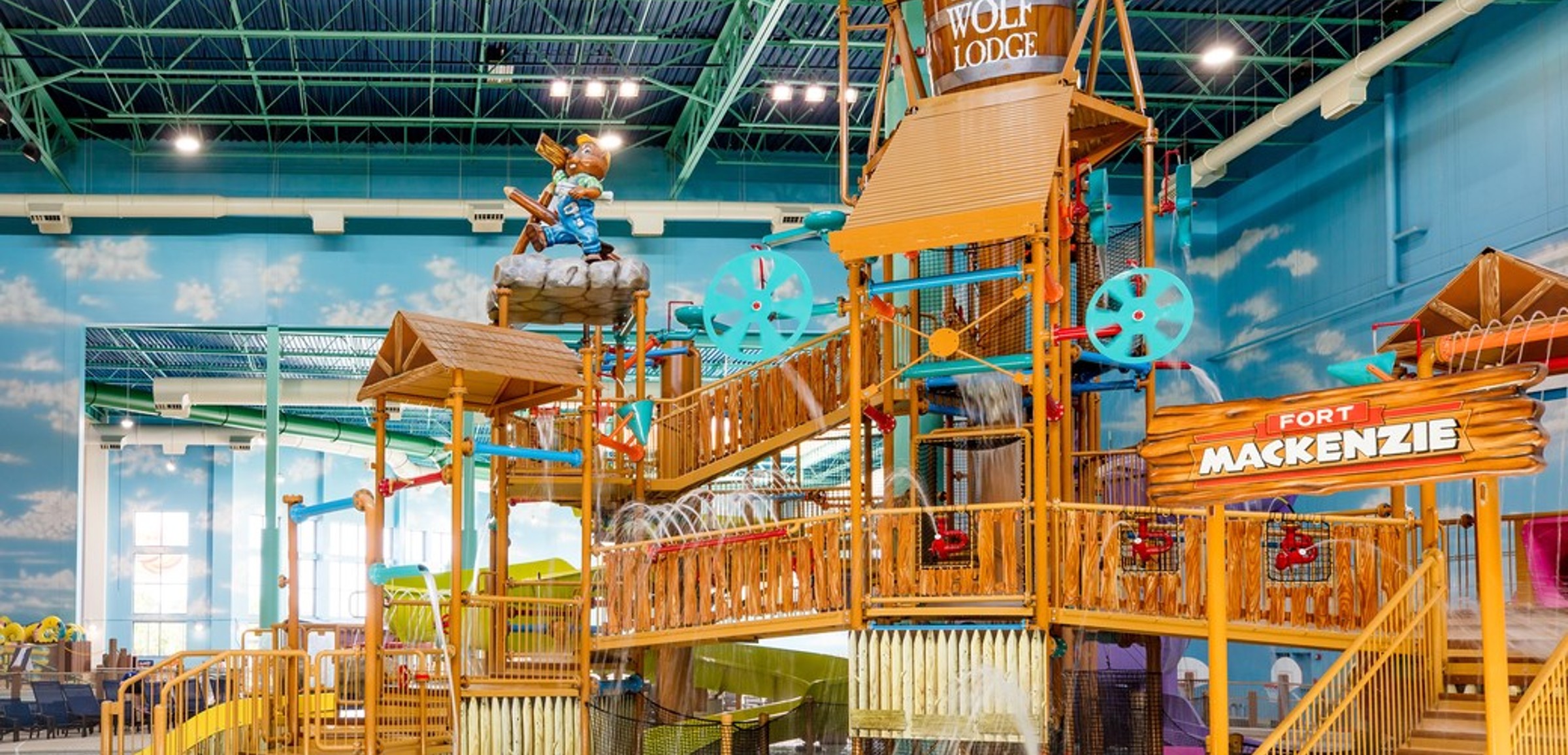 A wide shot of the  water treehouse as water splashes down from a bucket above the jungle gym
