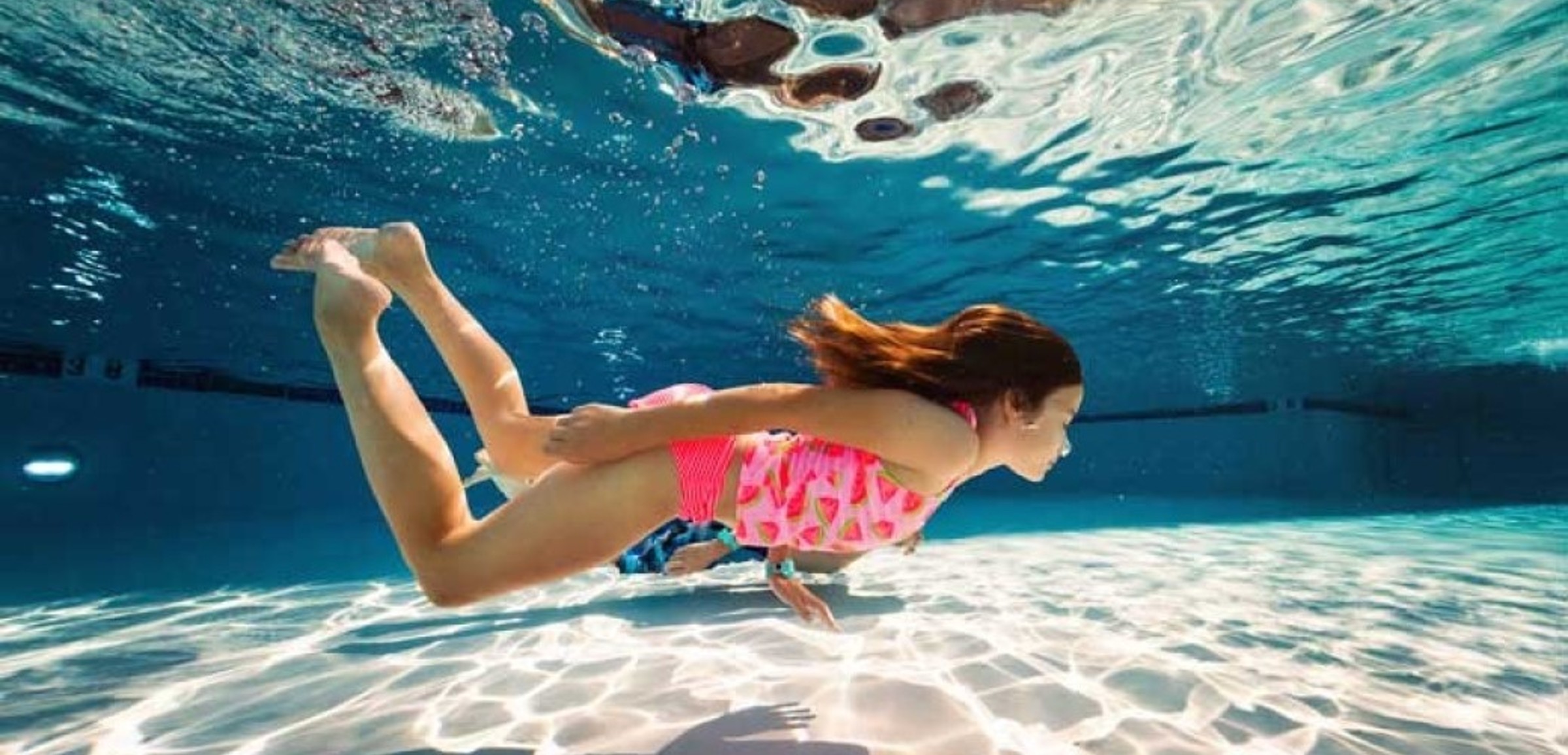 girl swimming under water