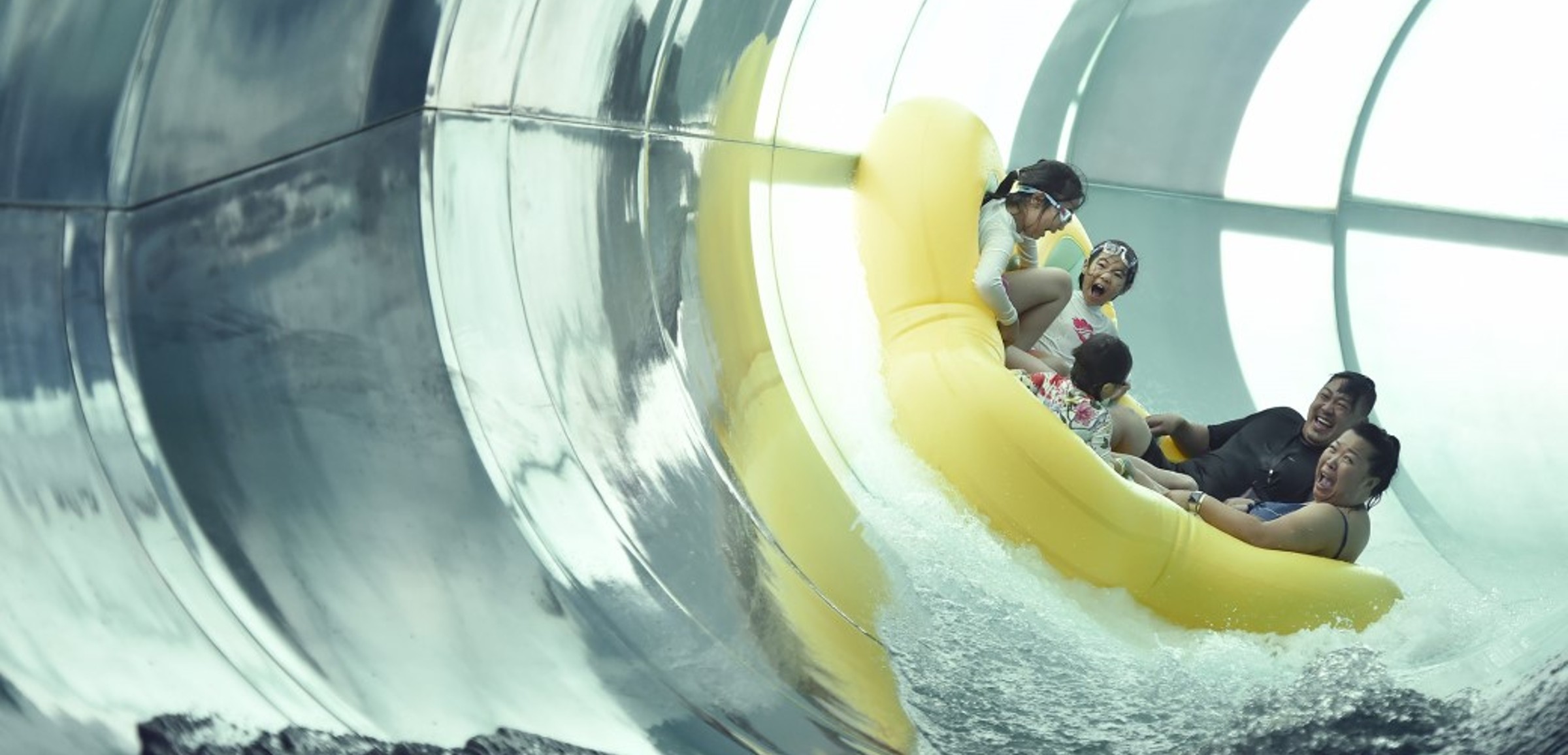 Family of five rides down enclosed waterslide 