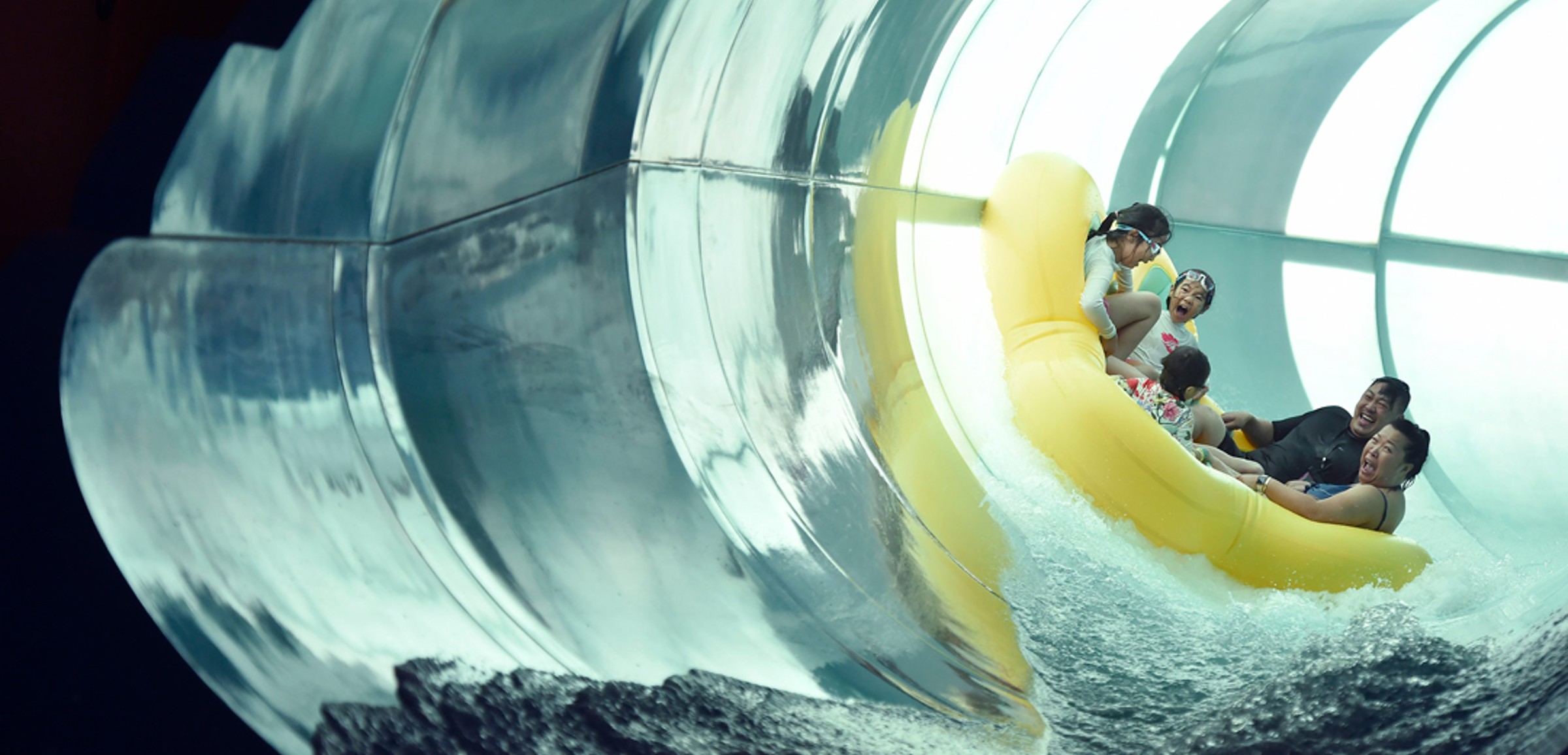 Family of five rides down enclosed waterslide 