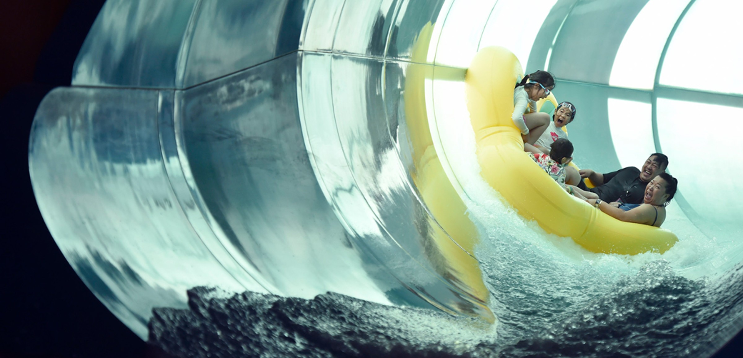 Family of five rides down enclosed waterslide 