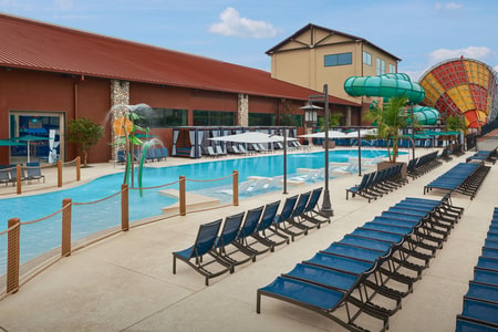 Kids play behind the outdoor water features 
