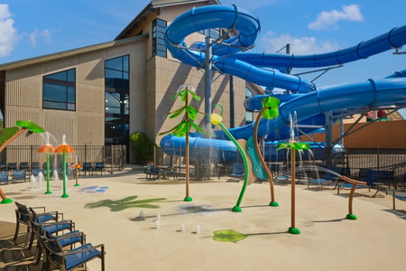 Kids play behind the outdoor water features 