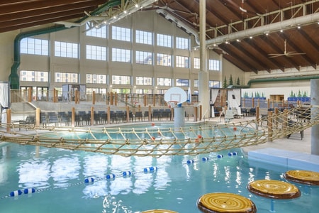 Indoor water park scene with a rope bridge