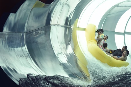 Family of five rides down enclosed water slide 