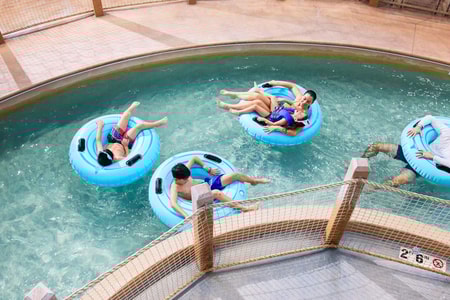 Family riding tubes enjoying the lazy river attraction