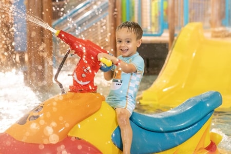 mother and child playing in a kiddie pool