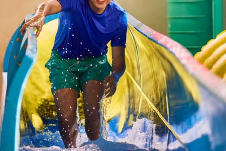 Teen enjoying water slide adventure ride