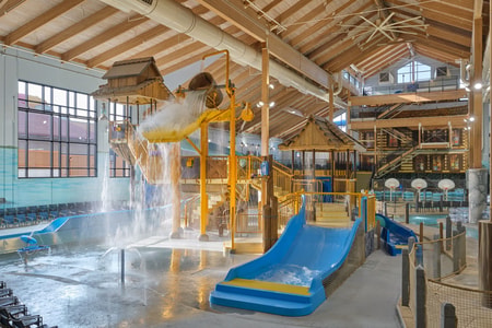 A wide shot of the water treehouse as water splashes down from a bucket