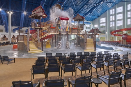 A wide shot of the water treehouse as water splashes down from a bucket