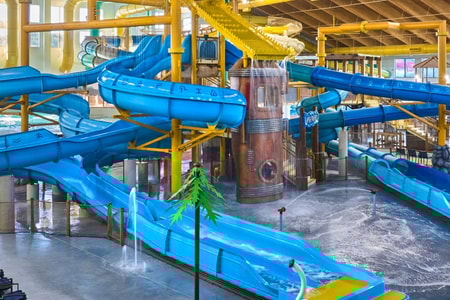 A wide shot of the water treehouse as water splashes down from a bucket