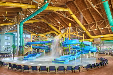 A wide shot of the water treehouse as water splashes down from a bucket