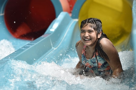 Teen going down a body water slide