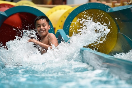 kid rides down waterslide