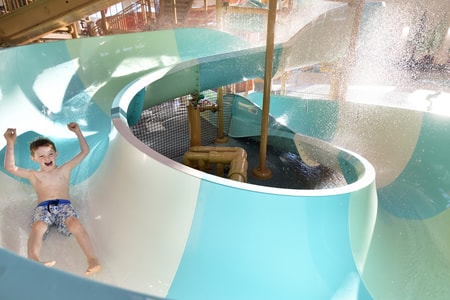 kid rides down waterslide