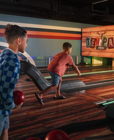 Guests playing bowling at the bowling alley