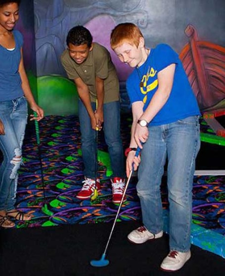 guests playing a game of mini golf