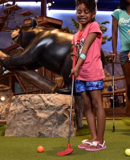 girl playing mini golf