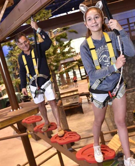 guests going over the rope course