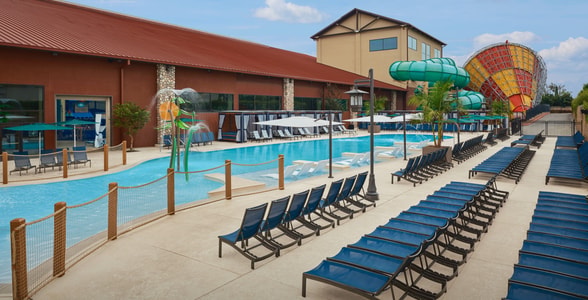 Kids play behind the outdoor water features 