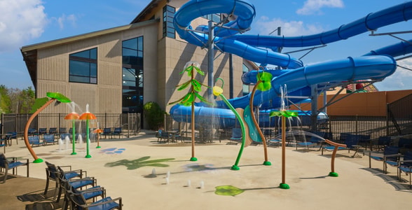 Kids play behind the outdoor water features 