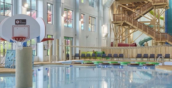 A large indoor pool equipped with a colorful water slide