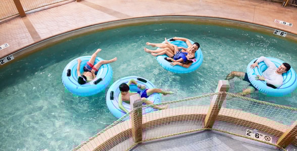 Family riding tubes enjoying the lazy river attraction
