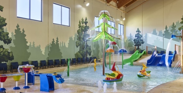 mother and child playing in a kiddie pool