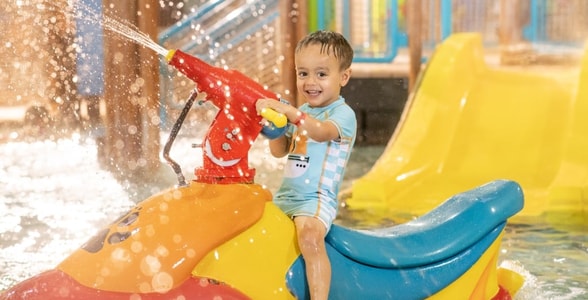 mother and child playing in a kiddie pool