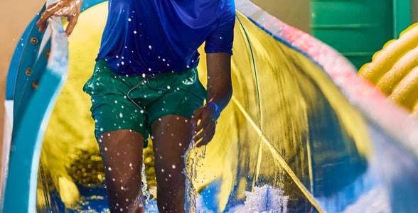 Teen enjoying water slide adventure ride