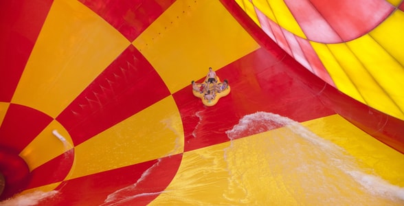 4 people on a 4-person tube riding dwn the howlin' tornado water park ride