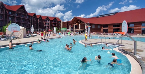 guests playing basketball in an outdoor pool