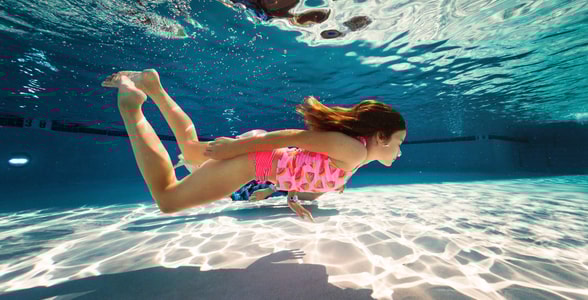 girl swimming under water