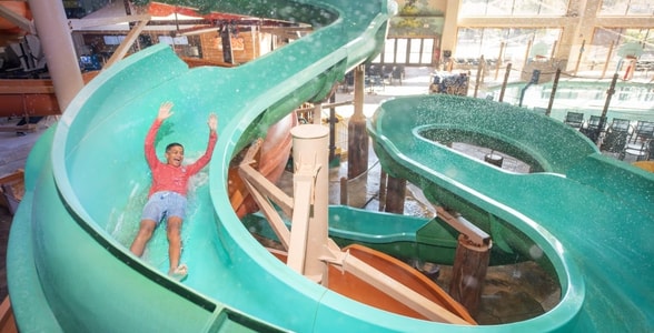 kid rides down waterslide