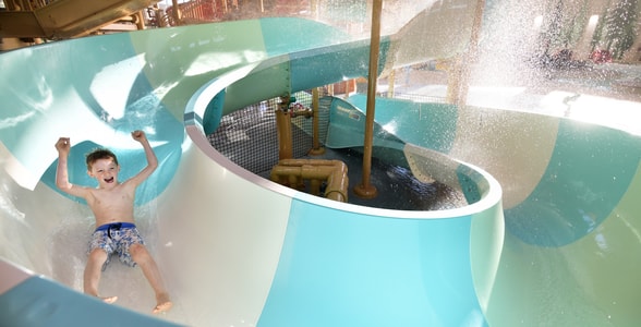 kid rides down waterslide