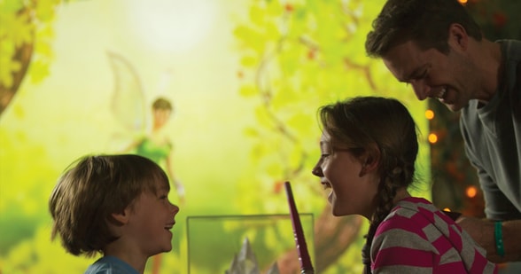 A young girl, her brother and dad having fun at the Pixie Encounter adventure