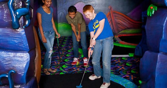 guests playing a game of mini golf