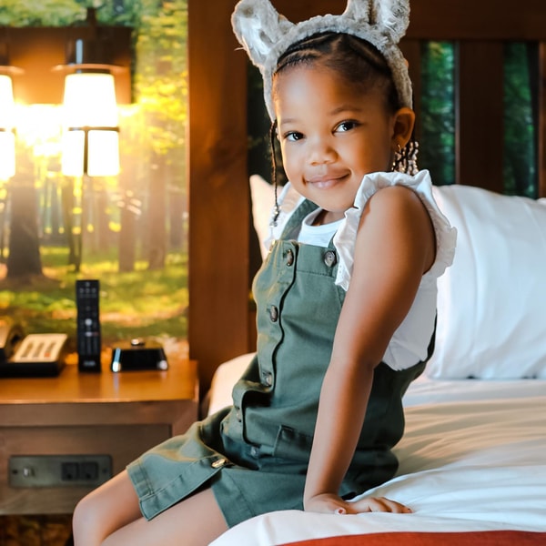 girl sitting on a bed