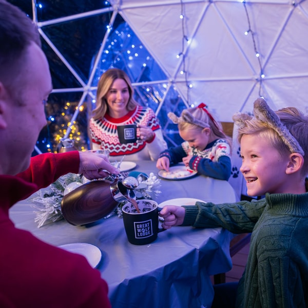 father serving hot chocolate