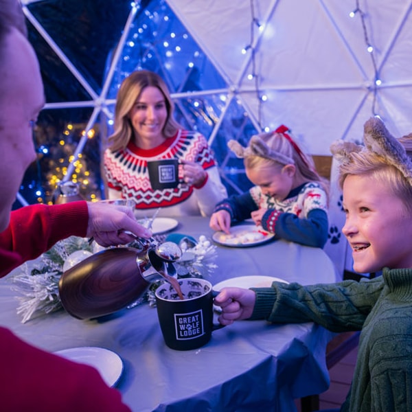 family enjoying time in a snow globe