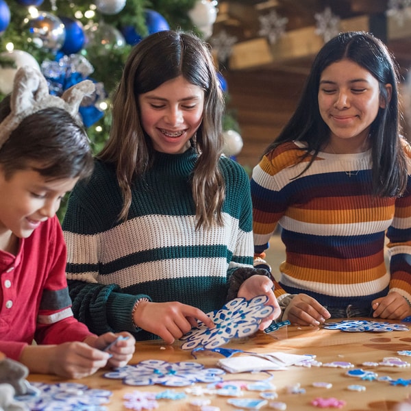 teenagers decorating holiday cookies
