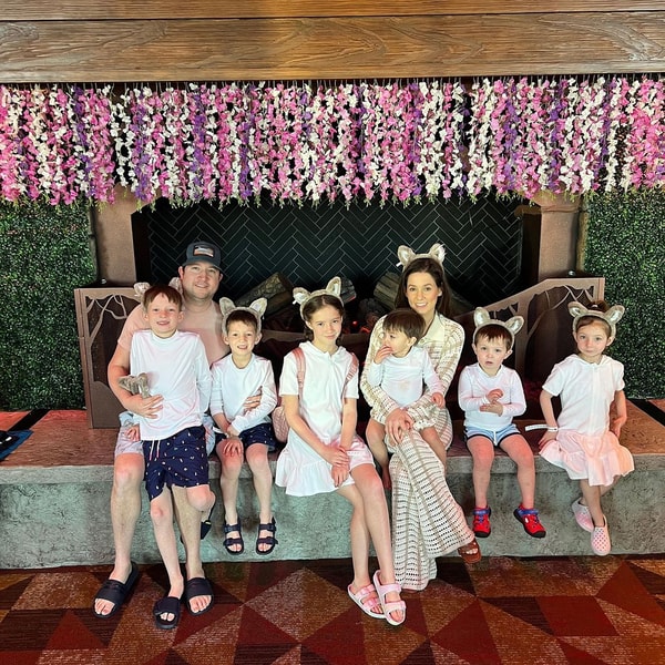 family sitting next to the fireplace